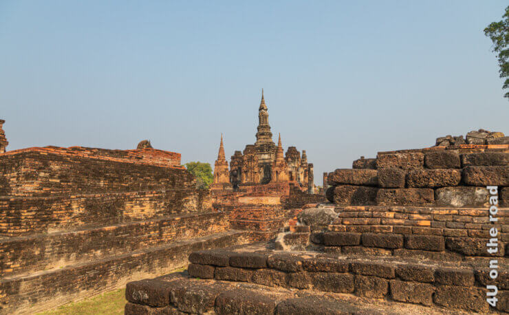 Ziegelsteinpyramiden und ein Ziegelsteintempel mit mehreren spitzen Türmen Feature Geschichtspark Sukhothai